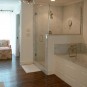 Wonderful White Mountain House Designed in Modern Building Style: Fantastic Bathroom Design Of Mountain Brook Road Home Interior With Glass Wall Shower Design And Bathtub With Storage Design Ideas